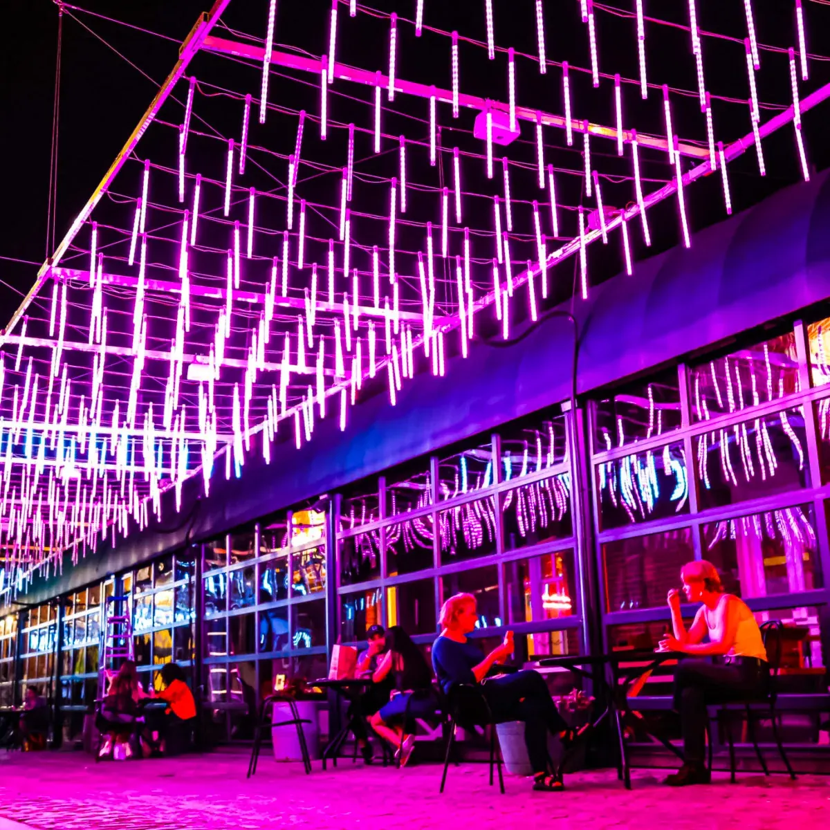 Evening outdoor gathering under cascading pink lights at the Georgetown Waterfront, Washington DC
