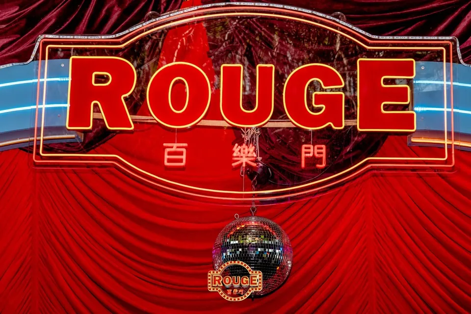 Rouge neon signage and disco ball above red velvet drape at Rouge, Darling Harbour Sydney