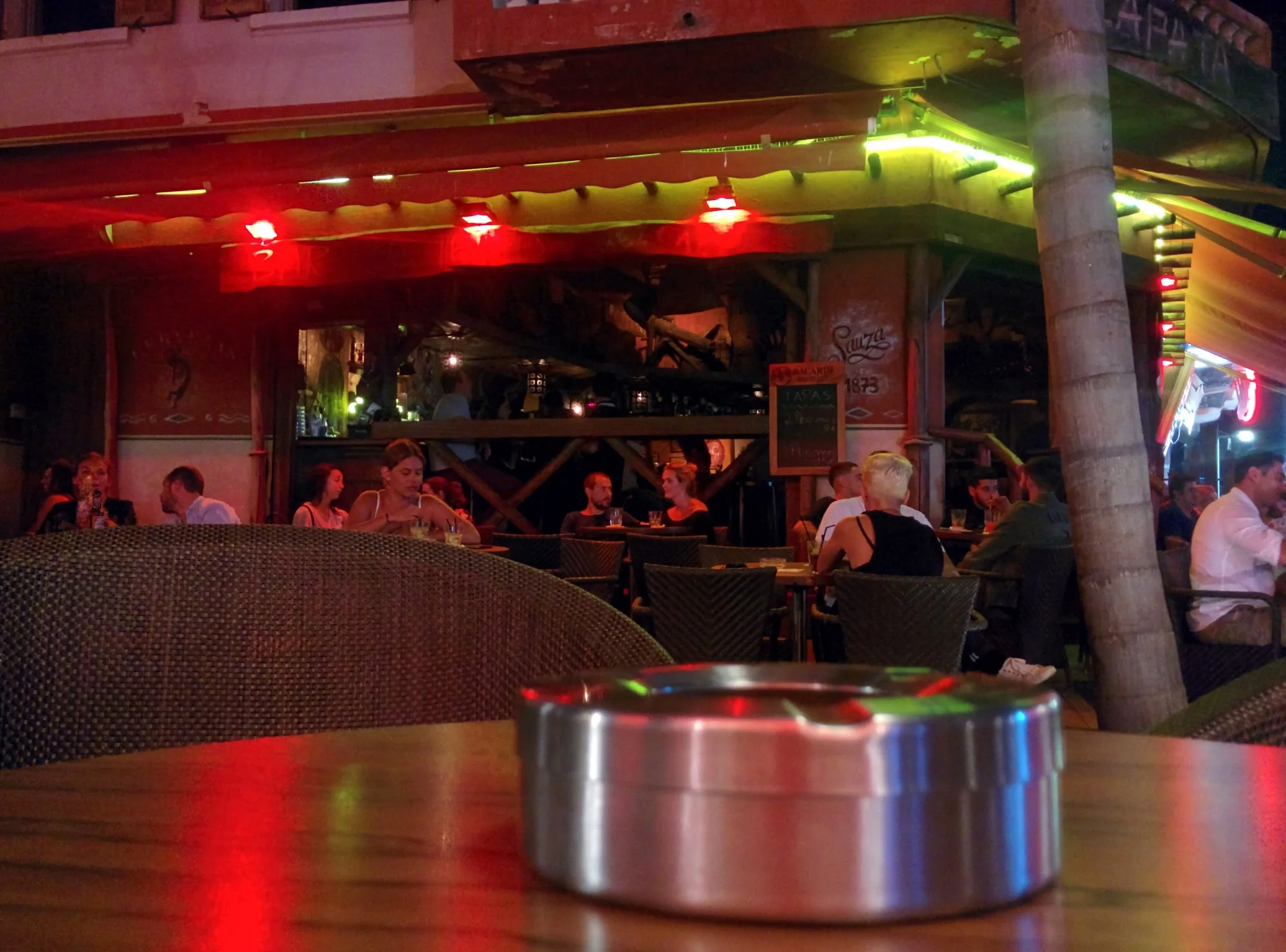 Outdoor bar terrace with crowd and red lighting at Zapata Juan-les-Pins at night