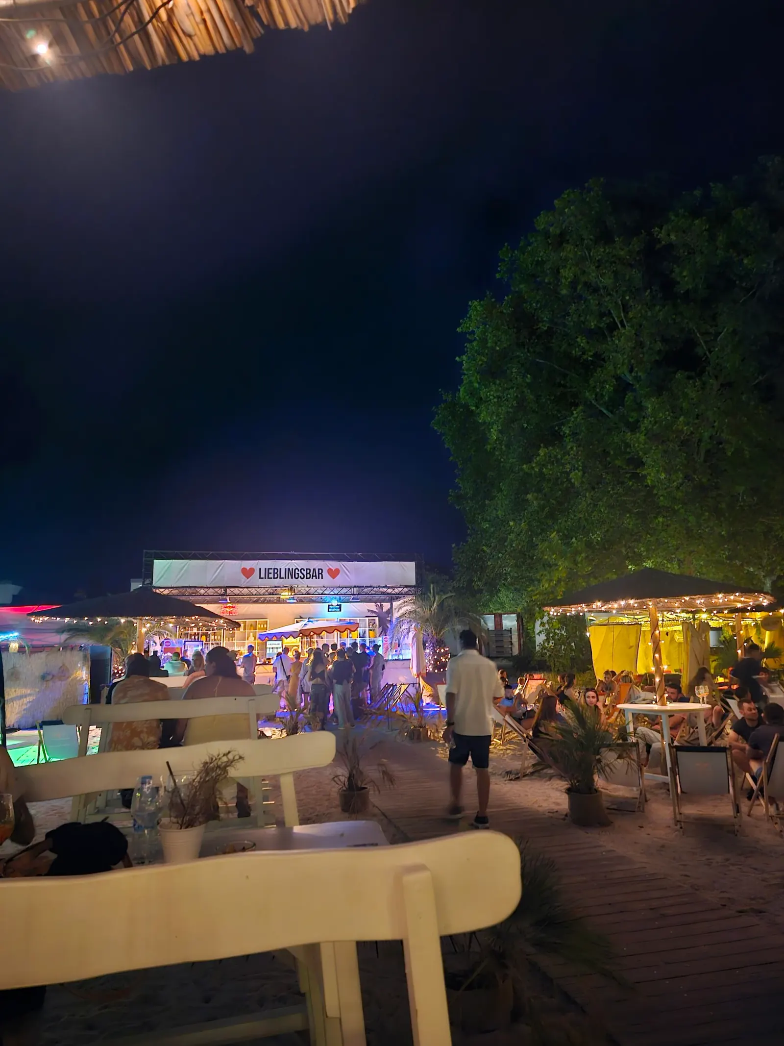 Lieblingsbar night event at Lieblingsstrand with crowd gathered under fairy lights and the venue lit up