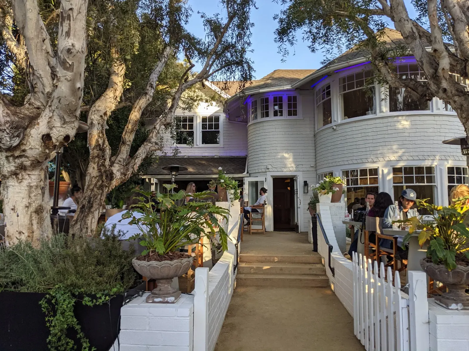 White wooden Victorian-style venue exterior with garden path in Los Angeles