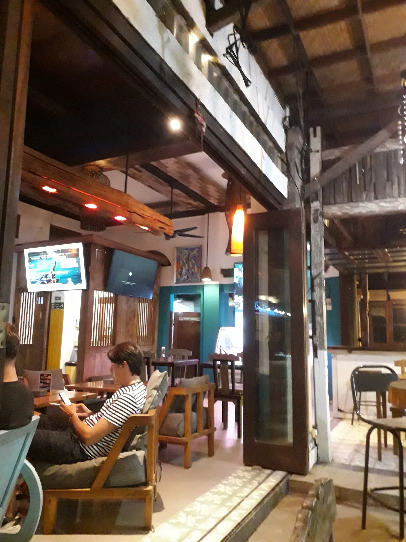 Warm wooden interior and lounge seating inside Litut Bar & Restaurant in Bali