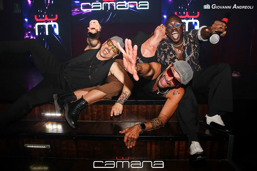 Performers posing on the Camana Club stage at a Latin dance night in Milan