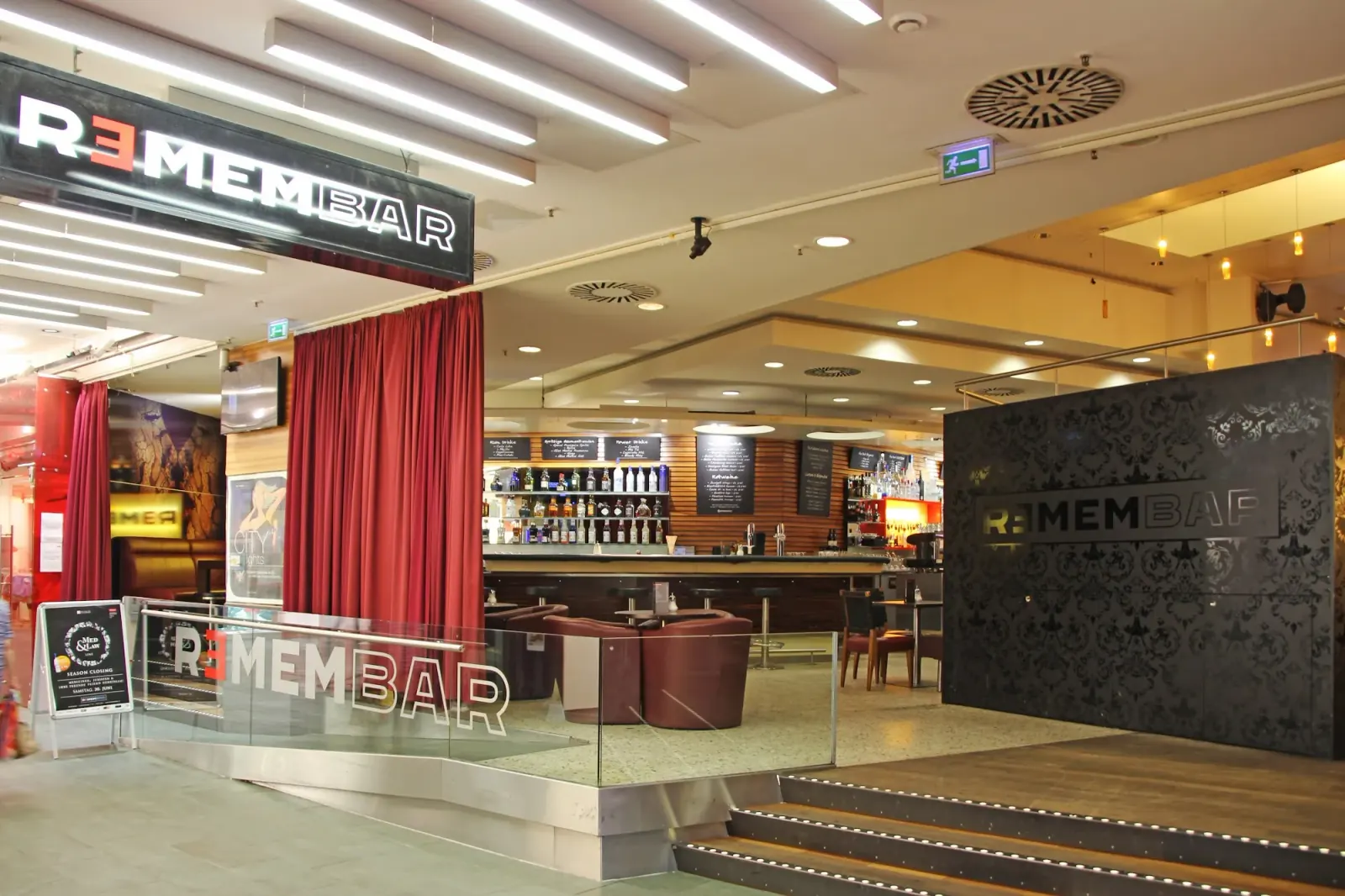 Remembar Frankfurt — branded bar entrance inside shopping mall with REMEMBAR neon and red curtain