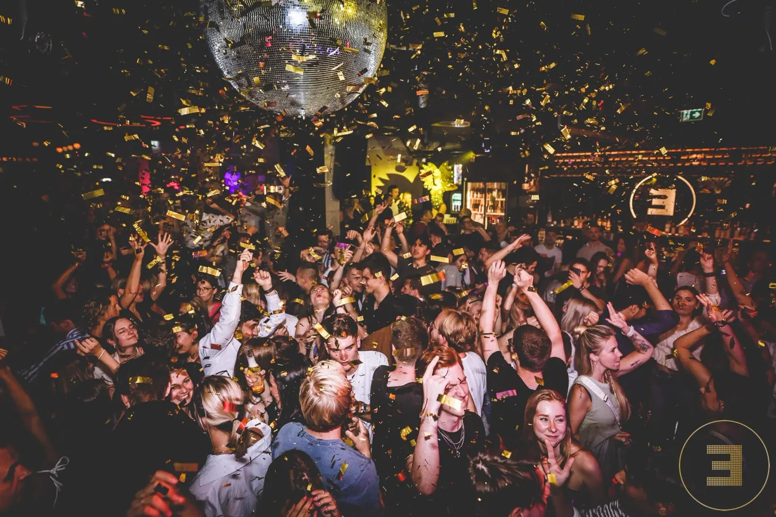Packed dance floor with confetti at Remembar club, Linz