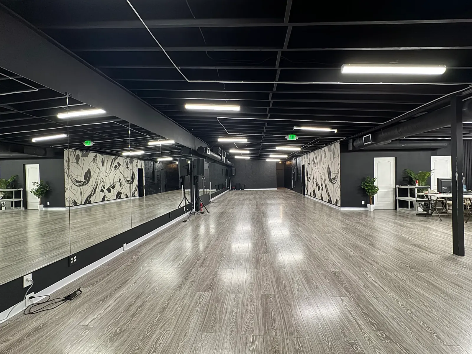 Large mirrored dance floor with wood-look flooring at RYG Dance Studio in North Hollywood