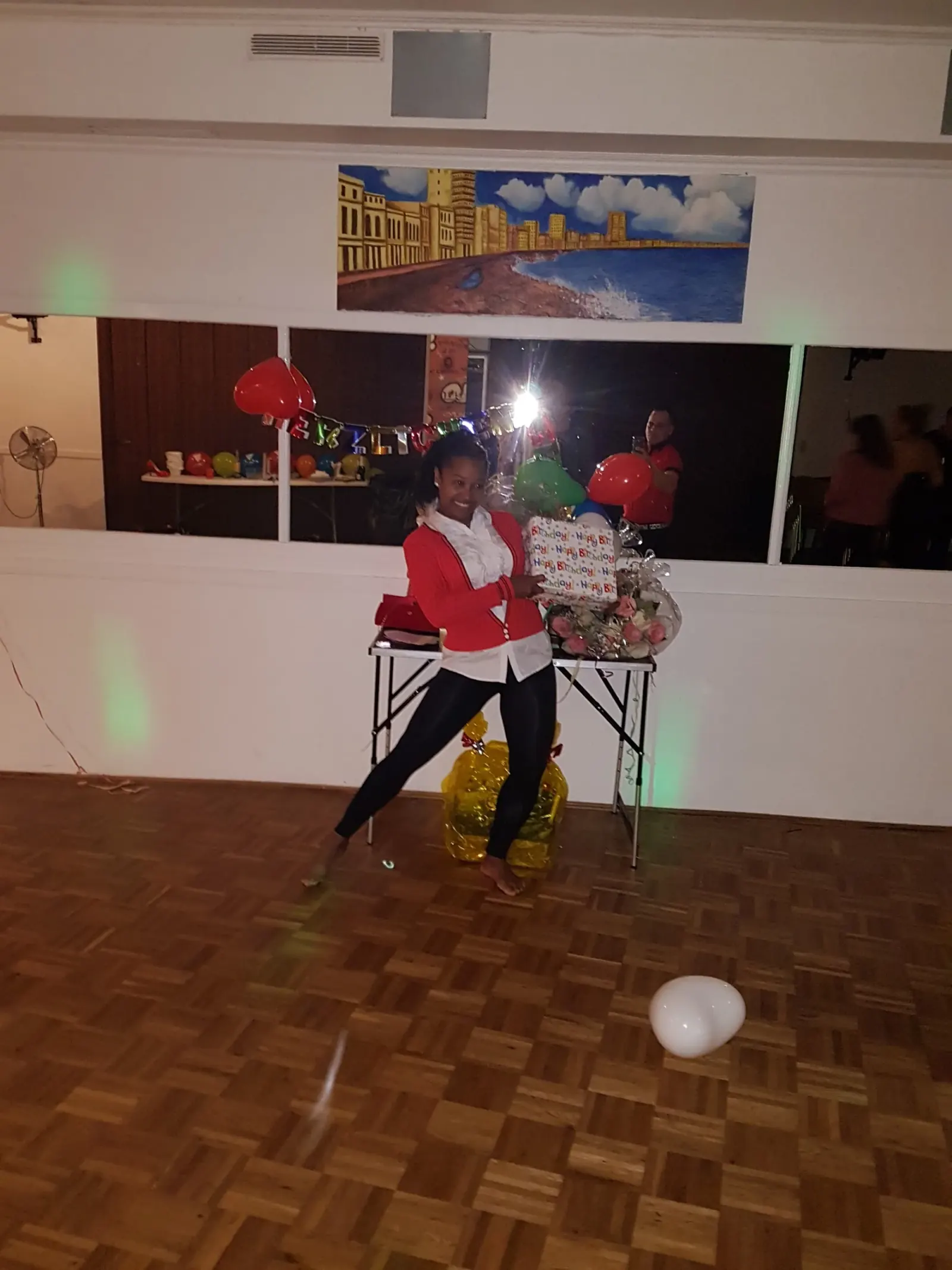 Woman dancing on wooden parquet floor at Casa Cultural Bremen party