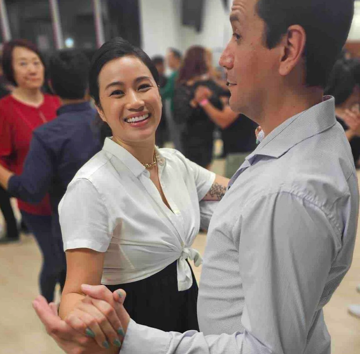 Couple in a partner dance hold at OC Salsa Dance Studio social in Fountain Valley