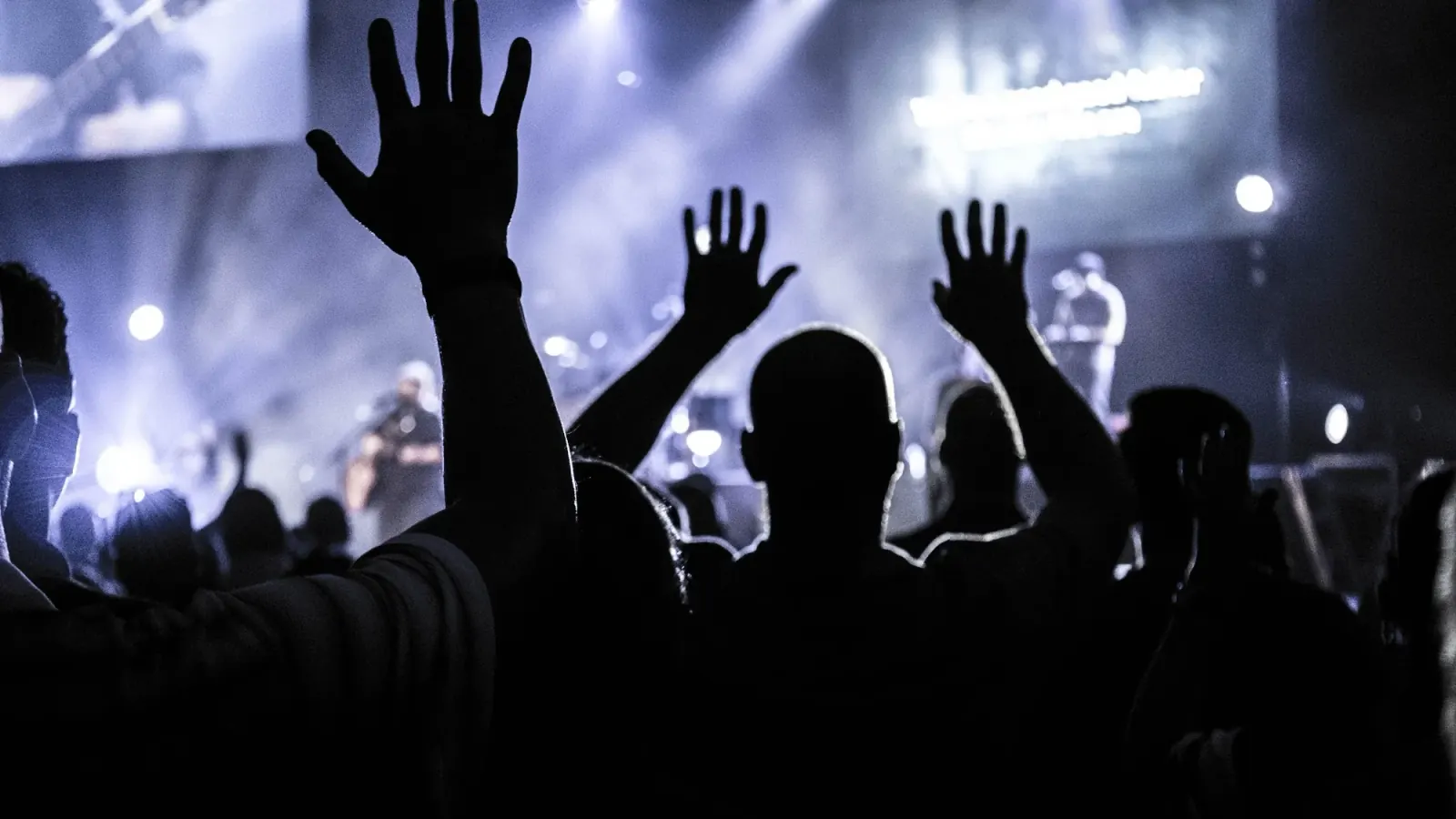 Crowd with raised hands under stage lights at Downstairs At The Dome in London