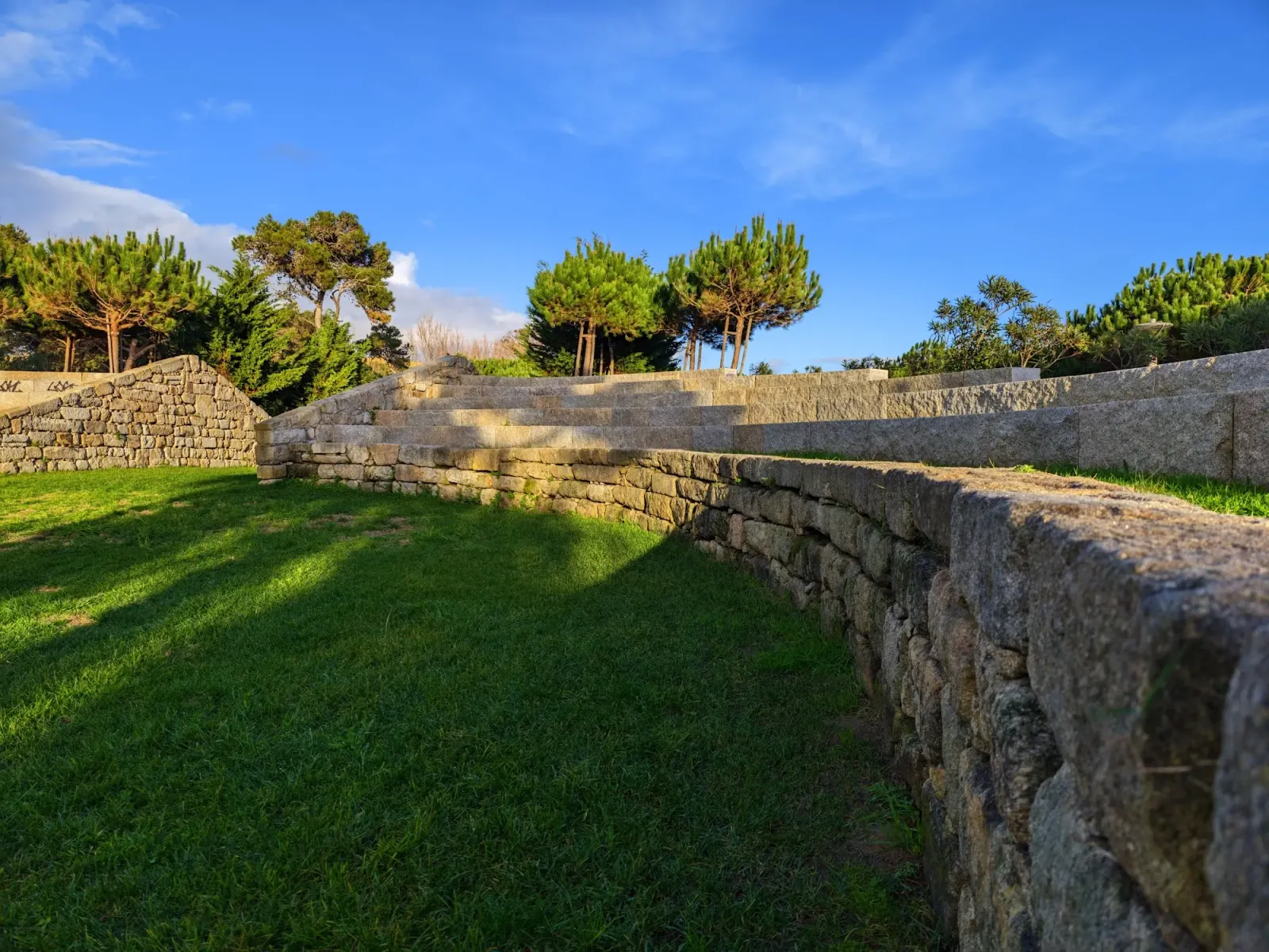 Stone amphitheater and grass terraces at Parque Urbano da Costa da Caparica