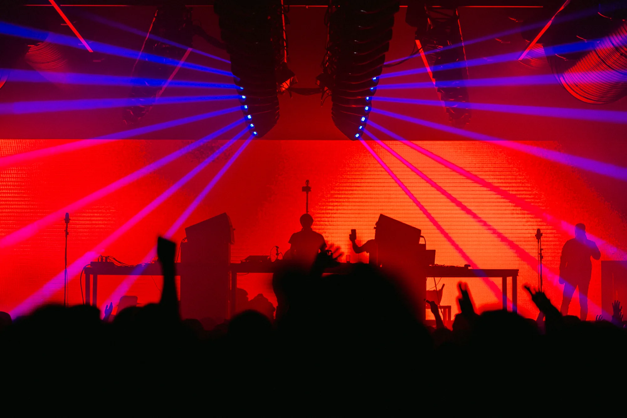 DJ with red and blue laser lights and crowd at Sala Pandora Seville nightclub