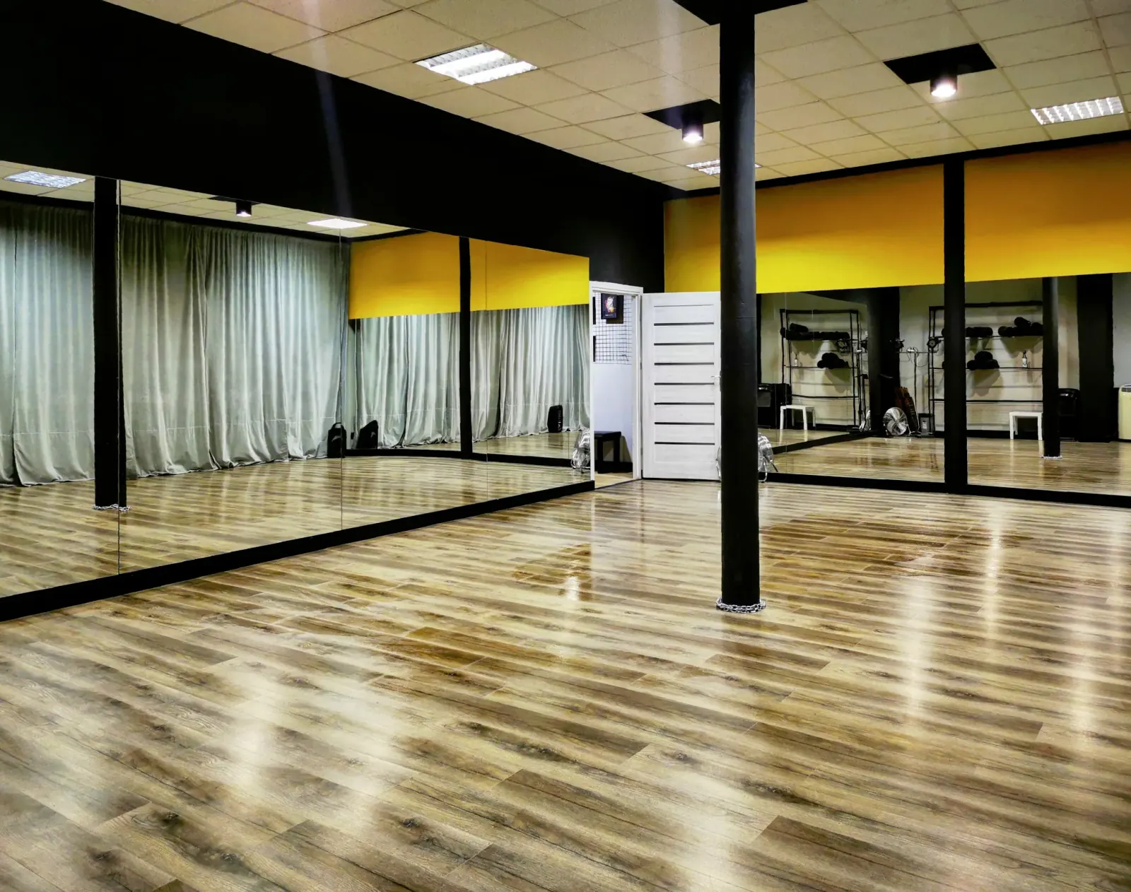TONdance dance studio with hardwood floor, mirrors, and black-yellow color scheme in Lodz