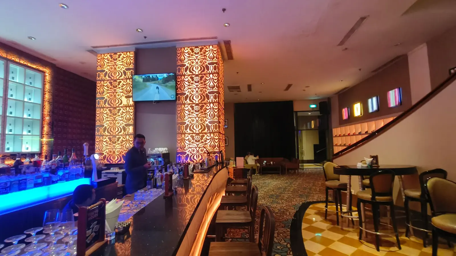 Blu Martini JW Marriott bar counter with bartender and lounge seating area